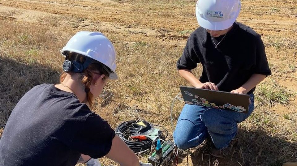 Engineering students testing soil onsite.